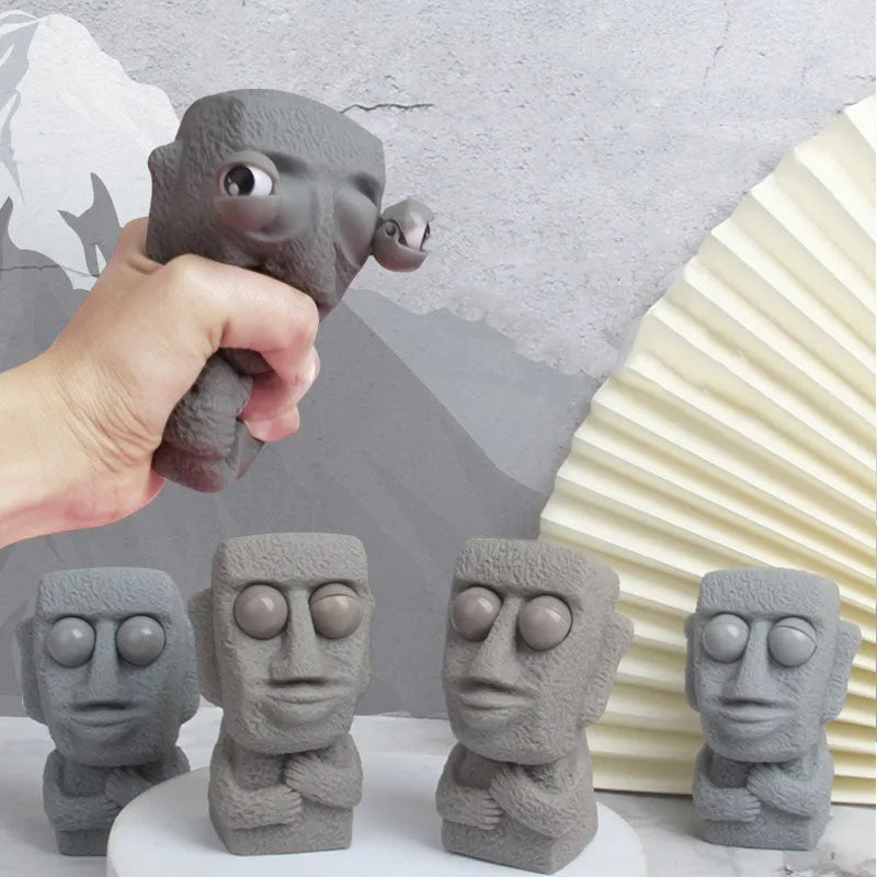 Stone man releases stress toy slowly rebounds soft Moai statue squeeze eyes interested expression relaxes stress children's gift